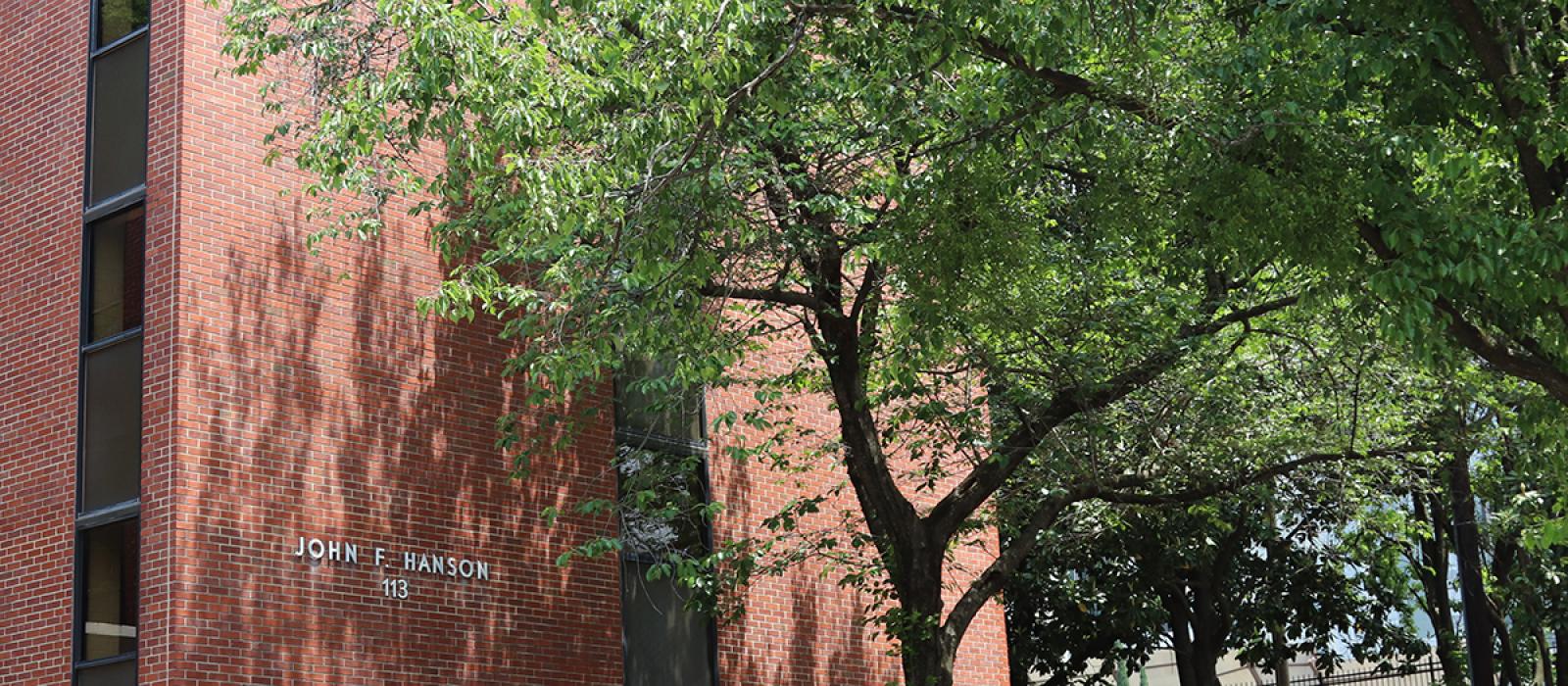 Hanson building with trees in front.