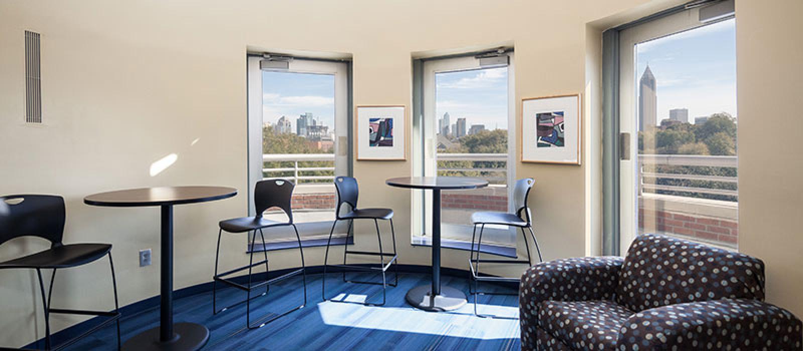 Atrium. Two big glass pane windows, one glass door with a view to Midtown Atlanta.