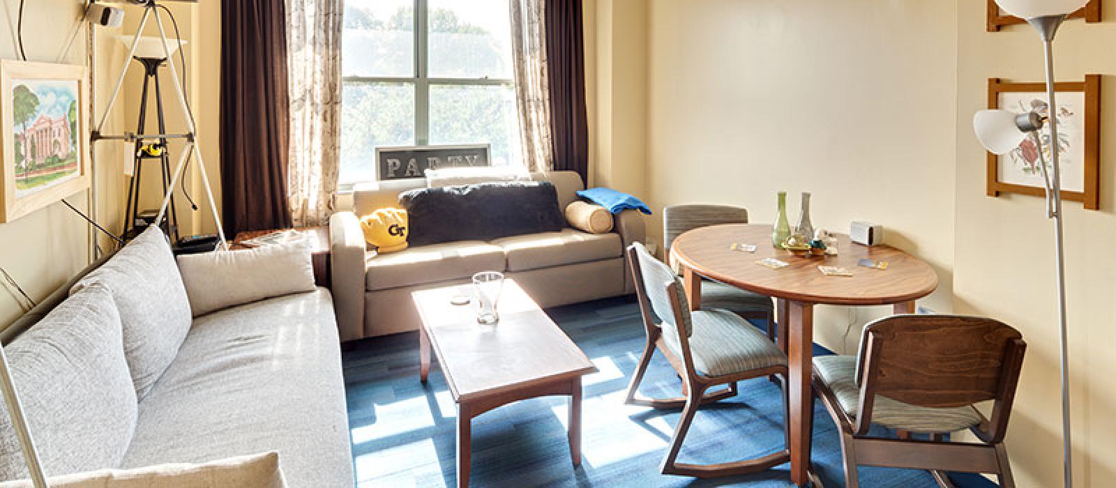 Living room with 2 sofas, coffee table and a small oval dinign table with 3 chairs.