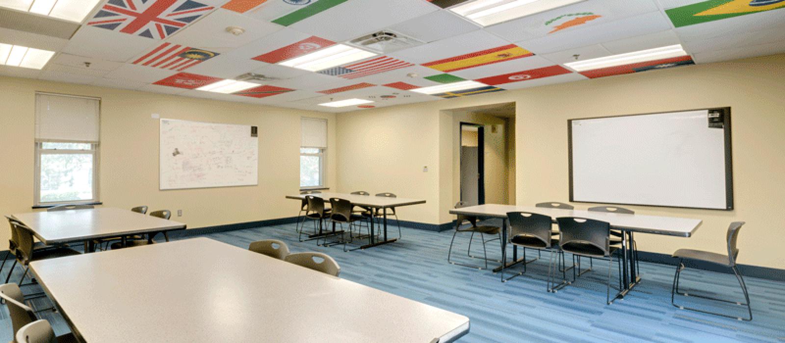 Meeting room with table, chairs and a white board.